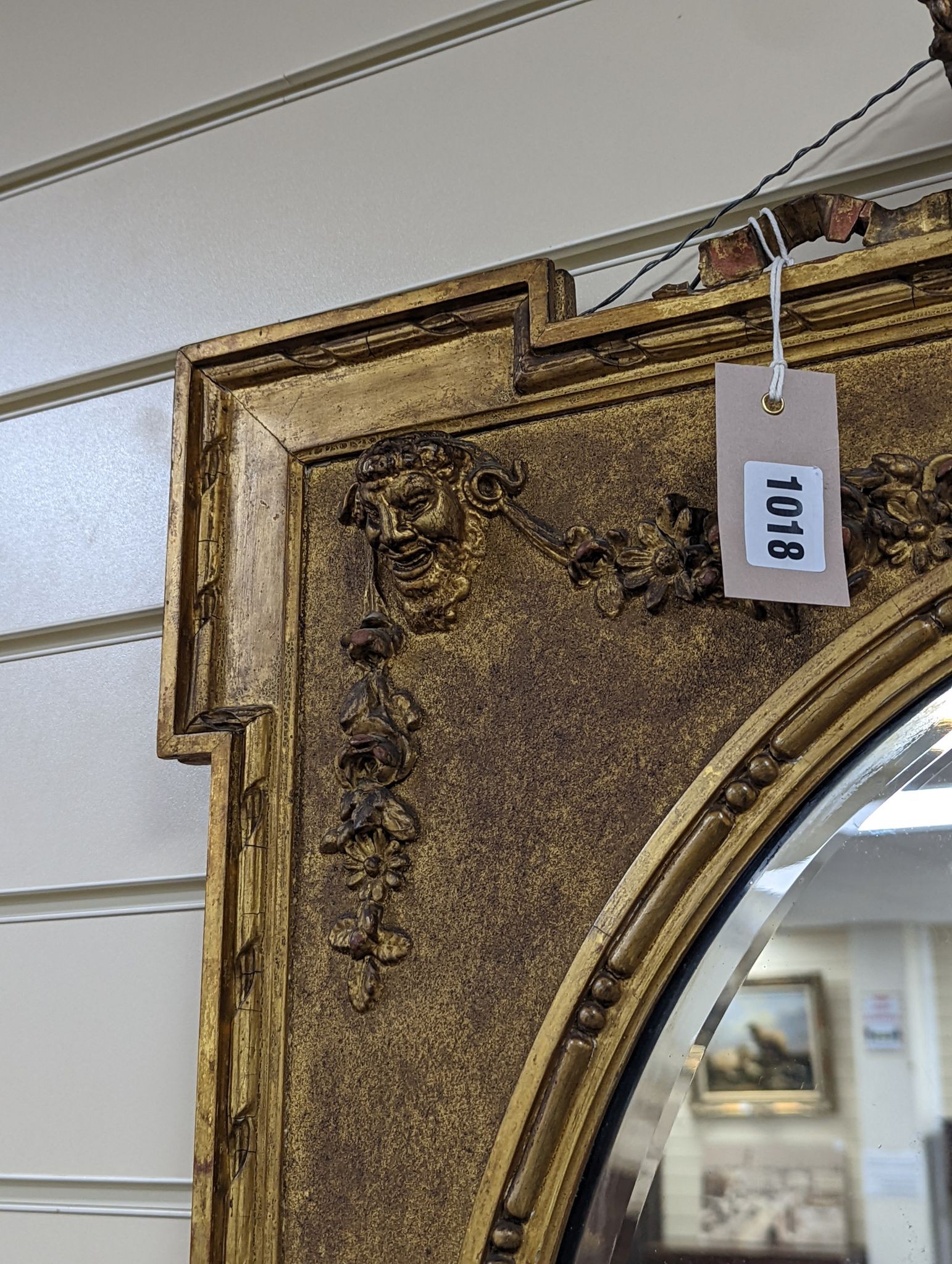 A Victorian style rectangular giltwood and gesso wall mirror, floral swag to top, with oval plate, width 70cm, height 92cm